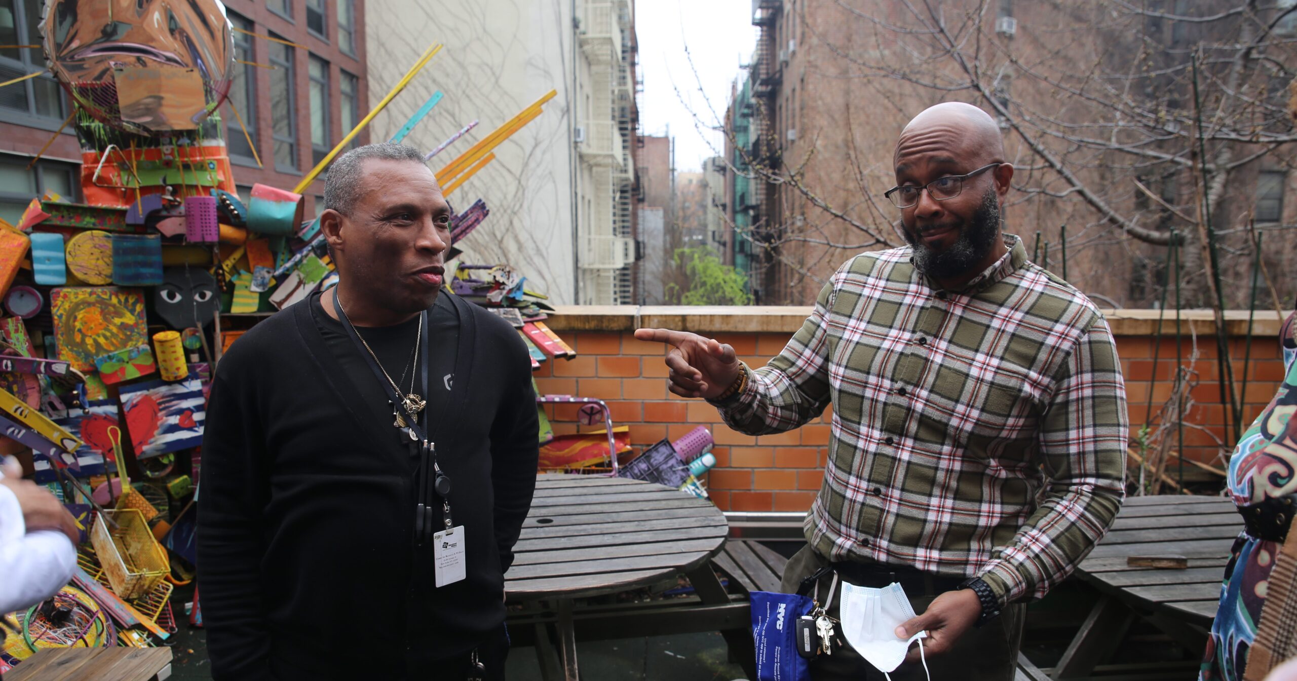 two people standing together outside, having a conversation