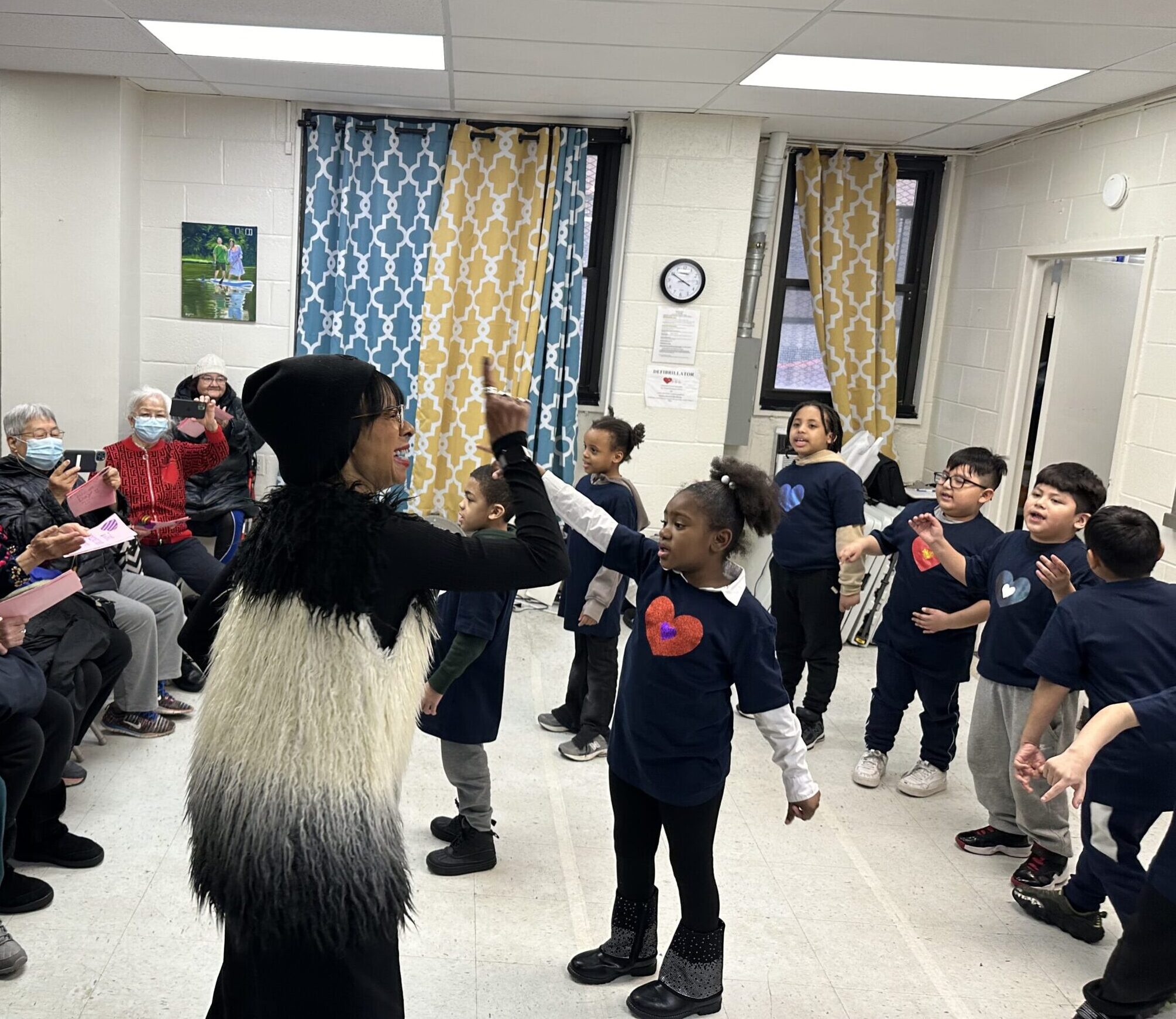 Image of a teacher helping a group of students with their work.